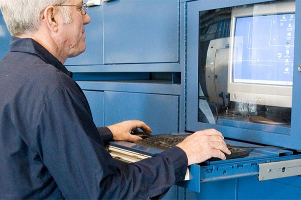 Man using a Vidmar computer cabinet